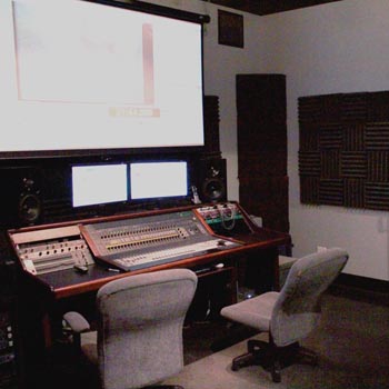 Production room with mixing console and large projection screen