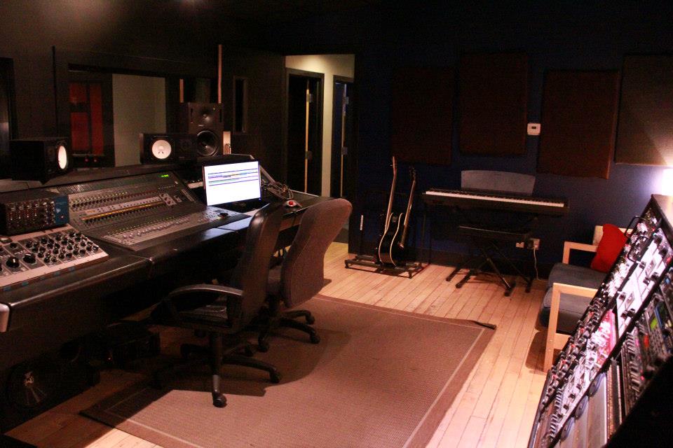 TallCat production room with mixing console, monitors, instruments, and outboard gear